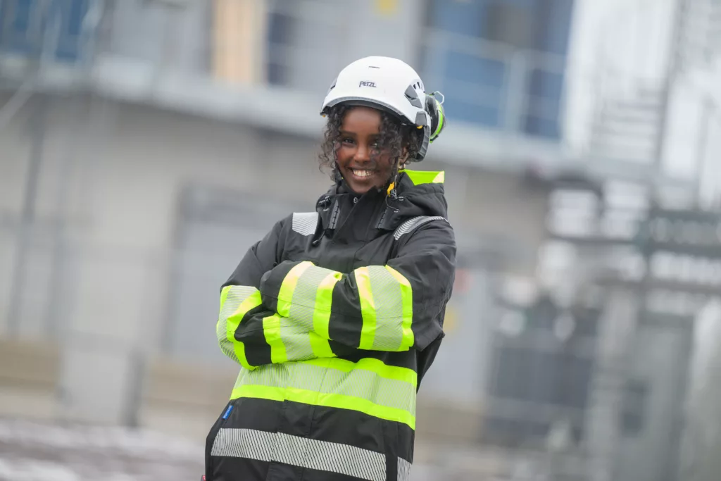 Young woman with helmet and a high-visibilty jacket