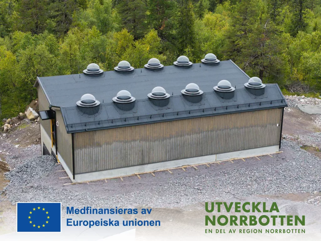 A brown house with 11 glass domes on the roof.