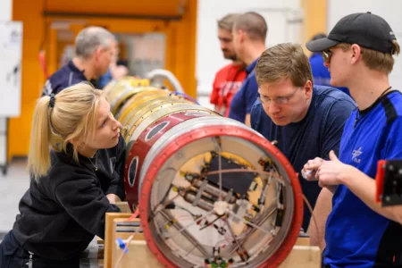 Engineers preparing a suborbital rocket for launch