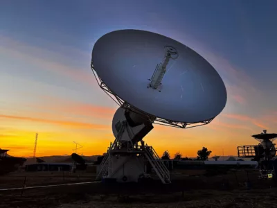Satellite antenna facing towards the blue and orange sky